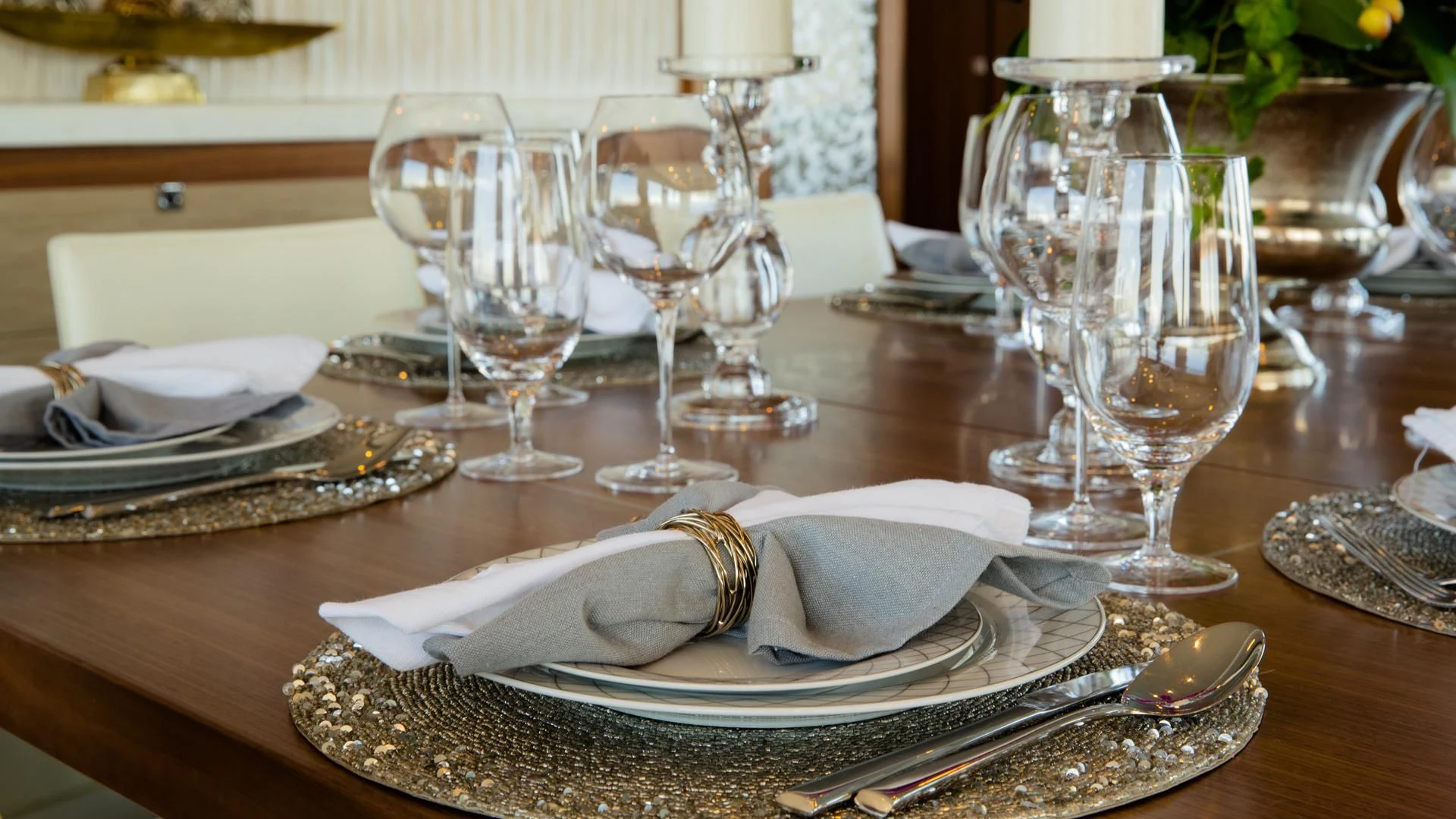 a table with plates and glasses aboard RISK TAKER Yacht for Charter