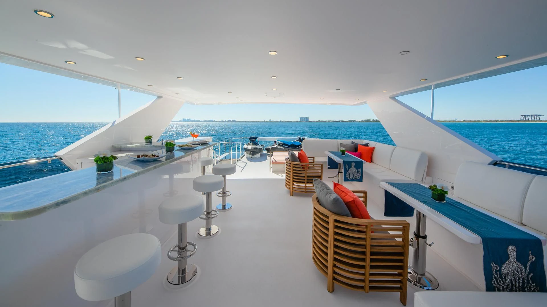 a room with a pool and a deck with chairs and a table aboard RISK TAKER Yacht for Charter