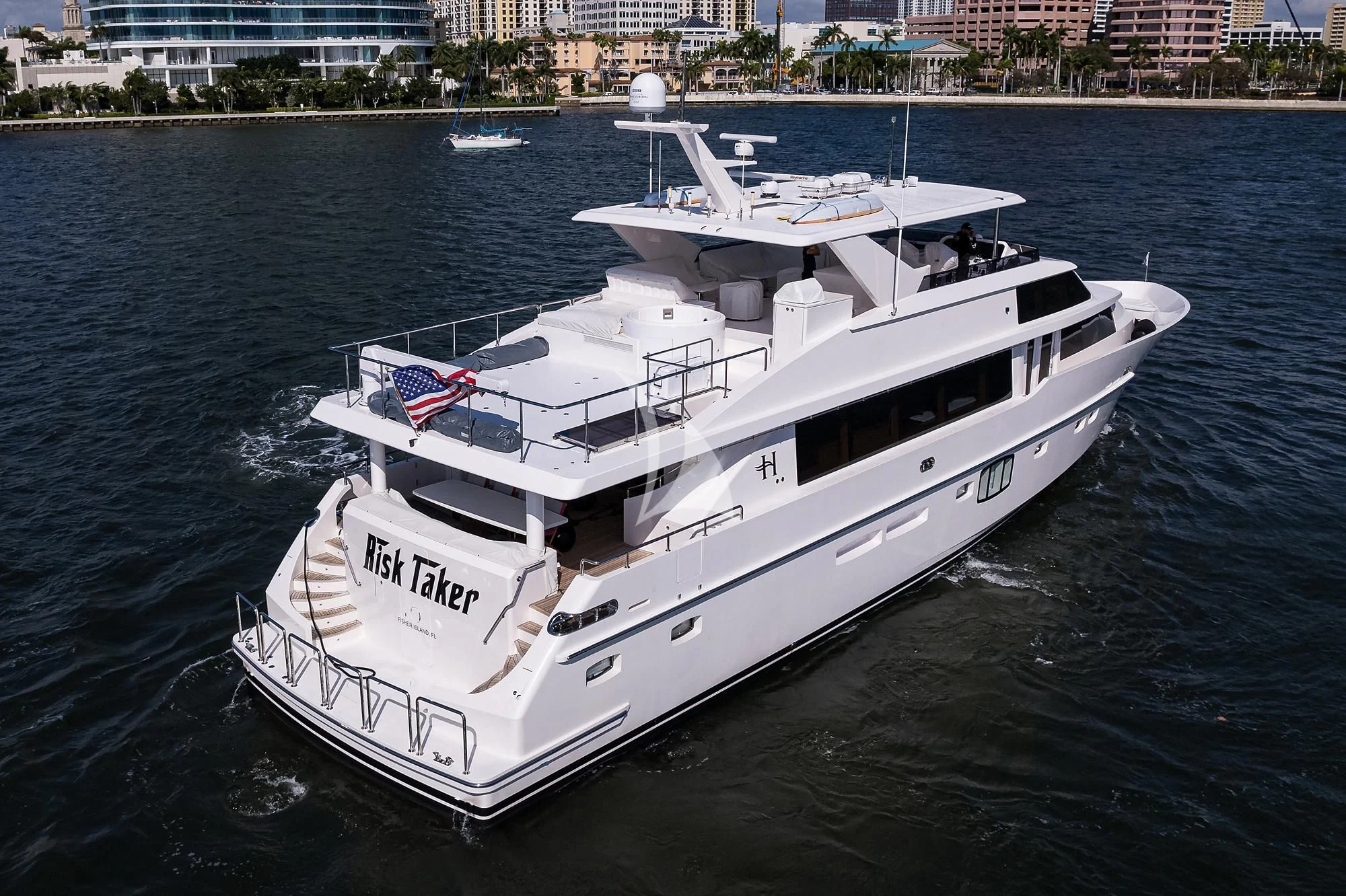 a white boat on the water aboard RISK TAKER Yacht for Charter