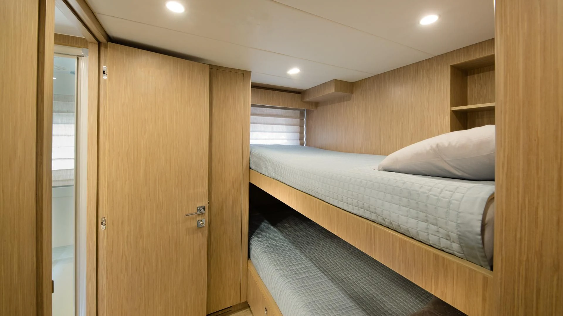 a bedroom with a bed and a closet aboard RISK TAKER Yacht for Charter