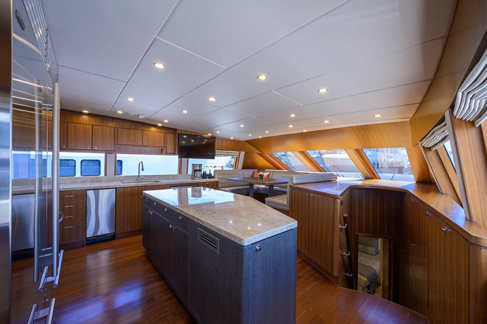 a kitchen with wooden cabinets aboard RISK TAKER Yacht for Charter