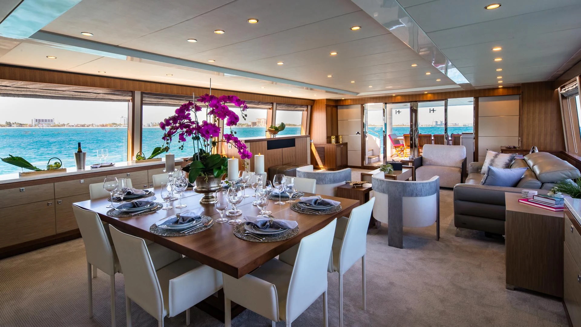 a large dining table in a large room with a large window aboard RISK TAKER Yacht for Charter