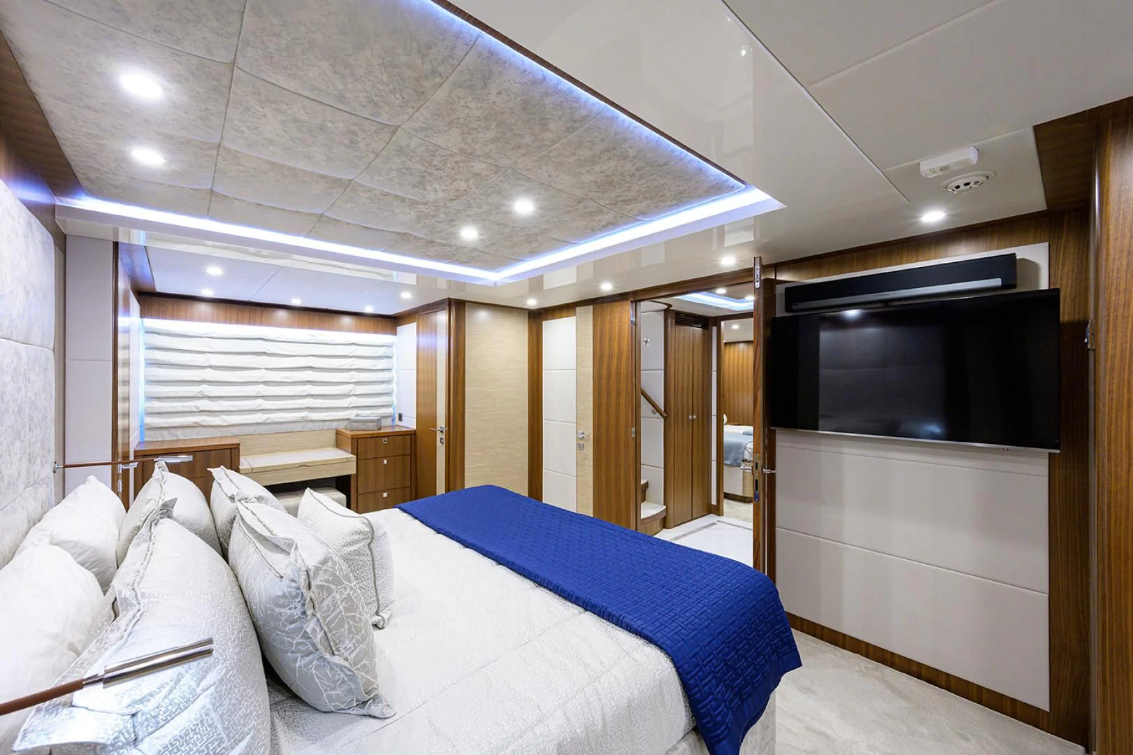 a bedroom with a bed and a tv aboard RISK TAKER Yacht for Charter