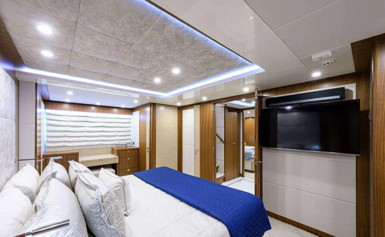 a room with a bed and a tv aboard RISK TAKER Yacht for Charter