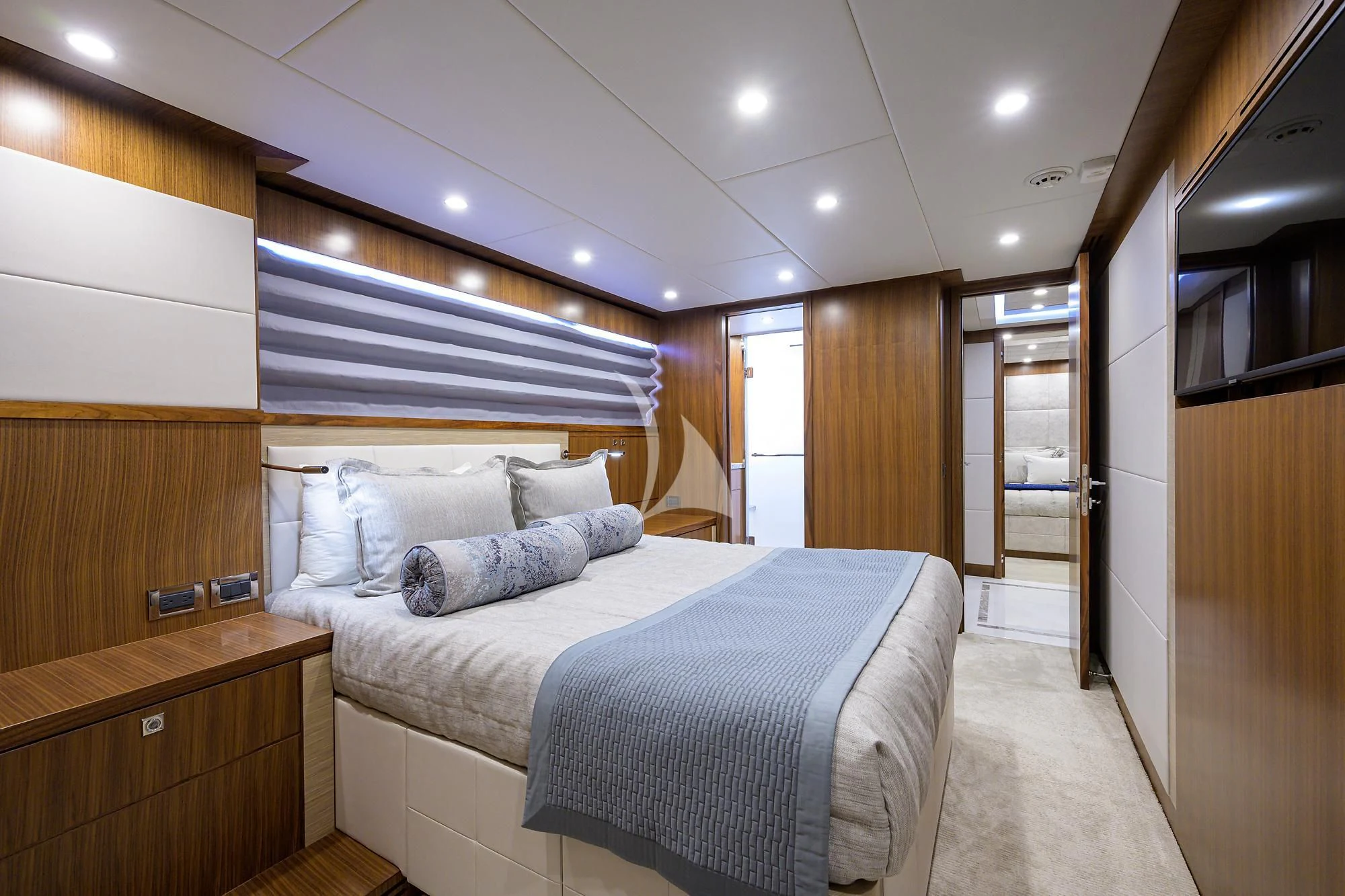 a bedroom with a bed and a closet aboard RISK TAKER Yacht for Charter