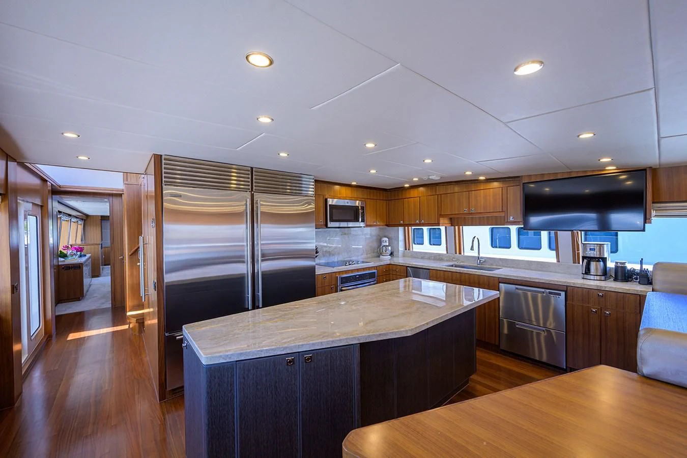 a kitchen with a stainless steel refrigerator aboard RISK TAKER Yacht for Charter