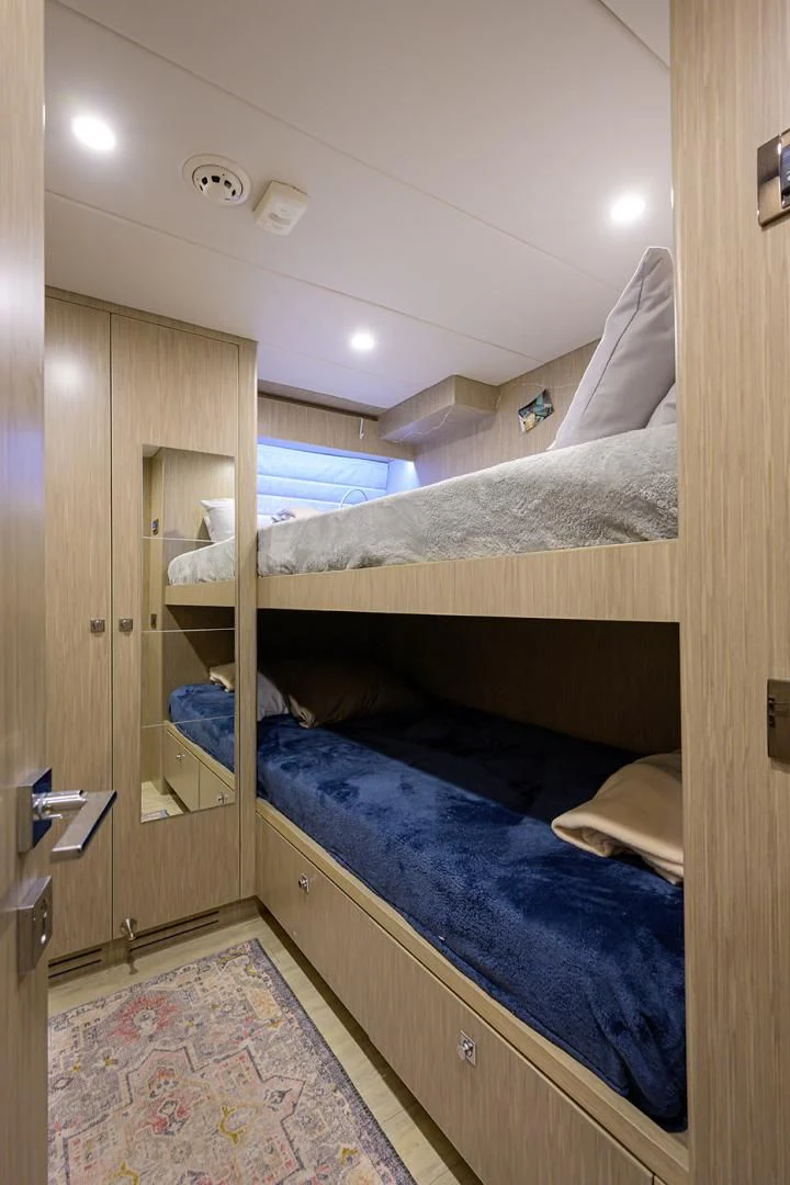 a room with bunk beds aboard RISK TAKER Yacht for Charter