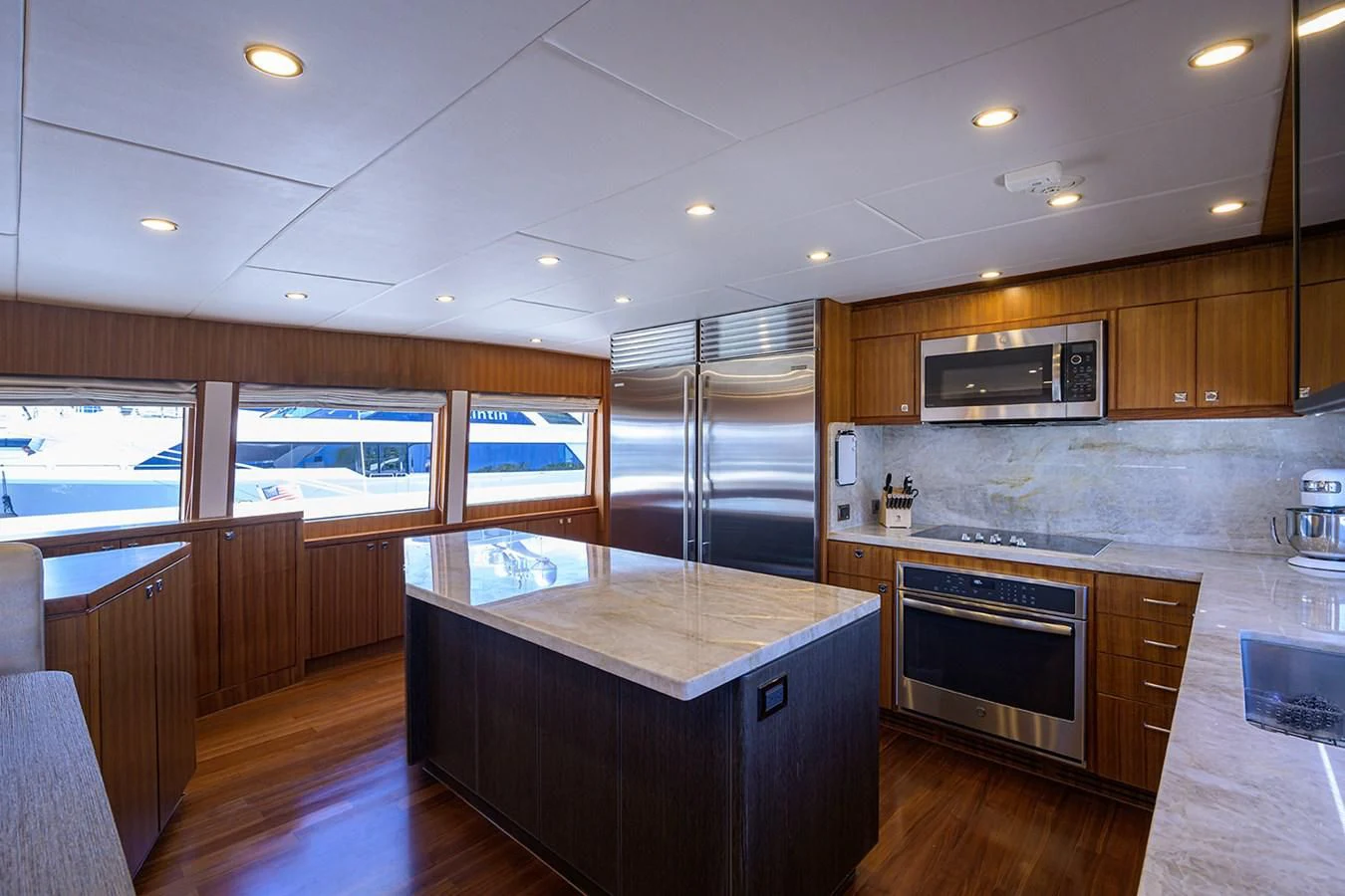 a kitchen with wooden cabinets aboard RISK TAKER Yacht for Charter