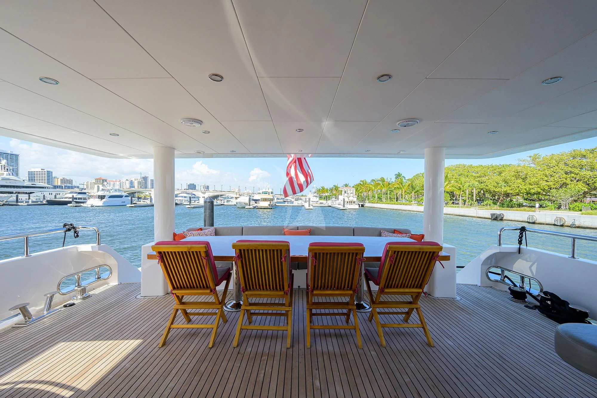 a deck with chairs and a table on it aboard RISK TAKER Yacht for Charter