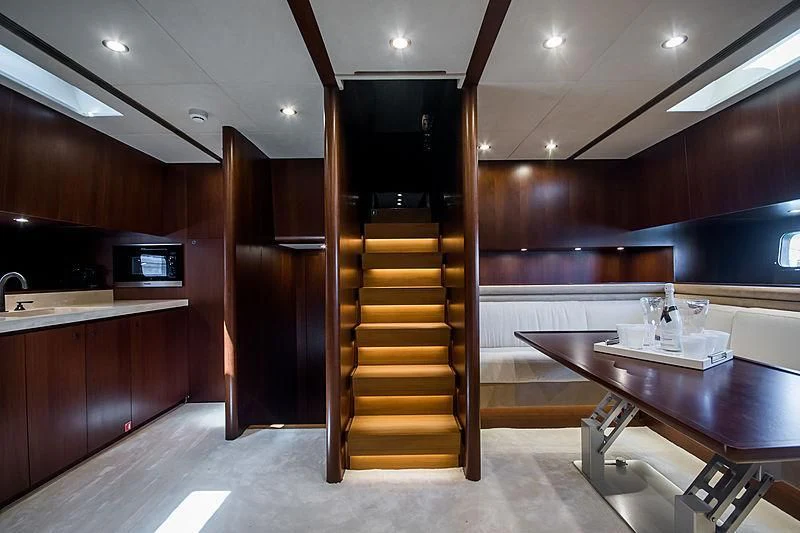 a kitchen with wooden cabinets aboard CARA MONTANA Yacht for Sale