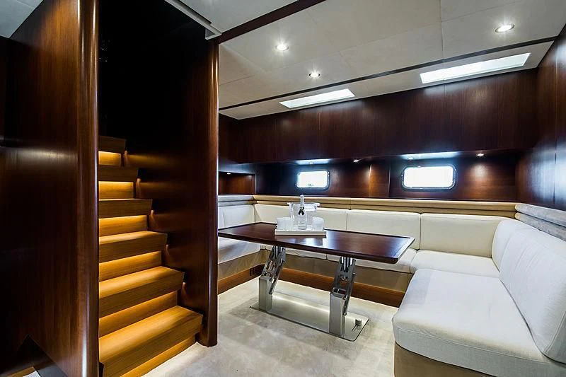 a room with a table and couch aboard CARA MONTANA Yacht for Sale