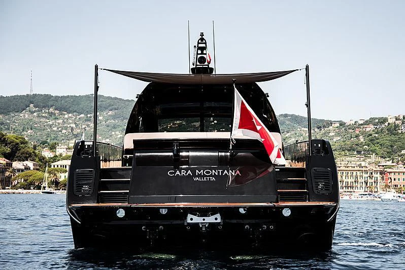 a boat with a flag on it aboard CARA MONTANA Yacht for Sale