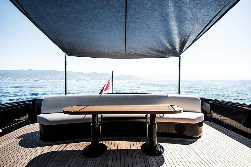 a table on a deck overlooking the ocean aboard CARA MONTANA Yacht for Sale