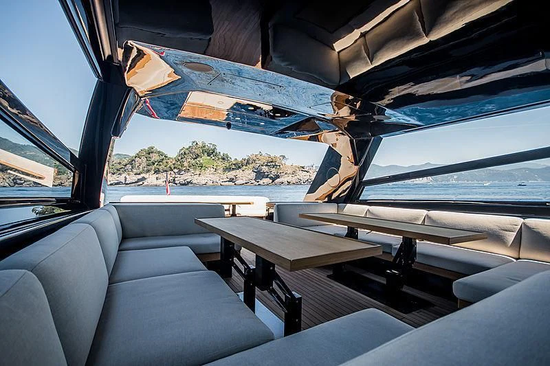 a boat with a table and chairs aboard CARA MONTANA Yacht for Sale
