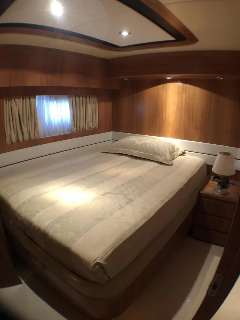 a bed with a white sheet aboard LADY J II Yacht for Sale