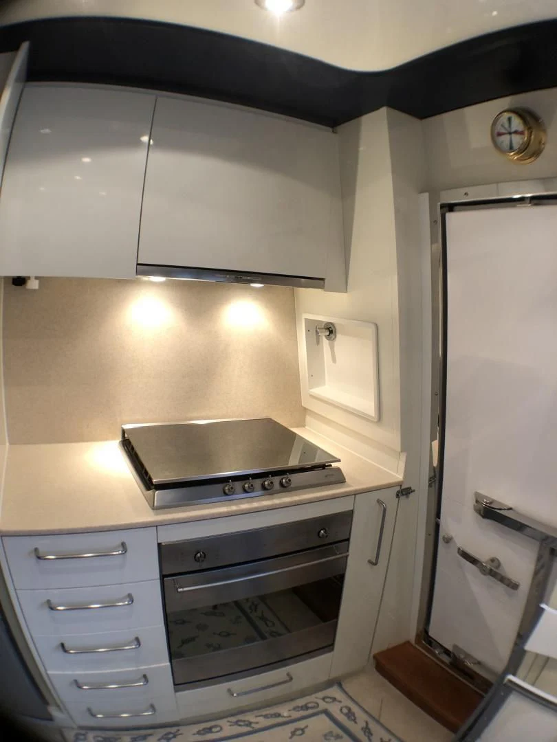 a kitchen with a stove and oven aboard LADY J II Yacht for Sale