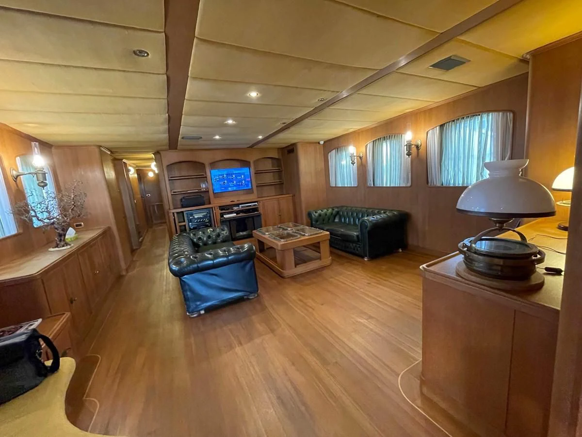 a living room with a large fireplace aboard SAN GENNARO Yacht for Sale