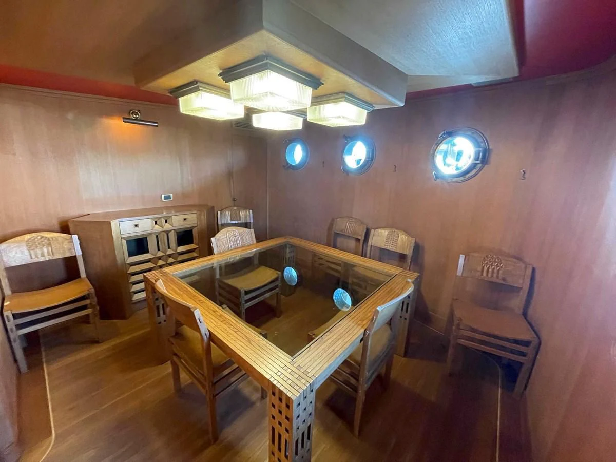 a room with a table and chairs aboard SAN GENNARO Yacht for Sale