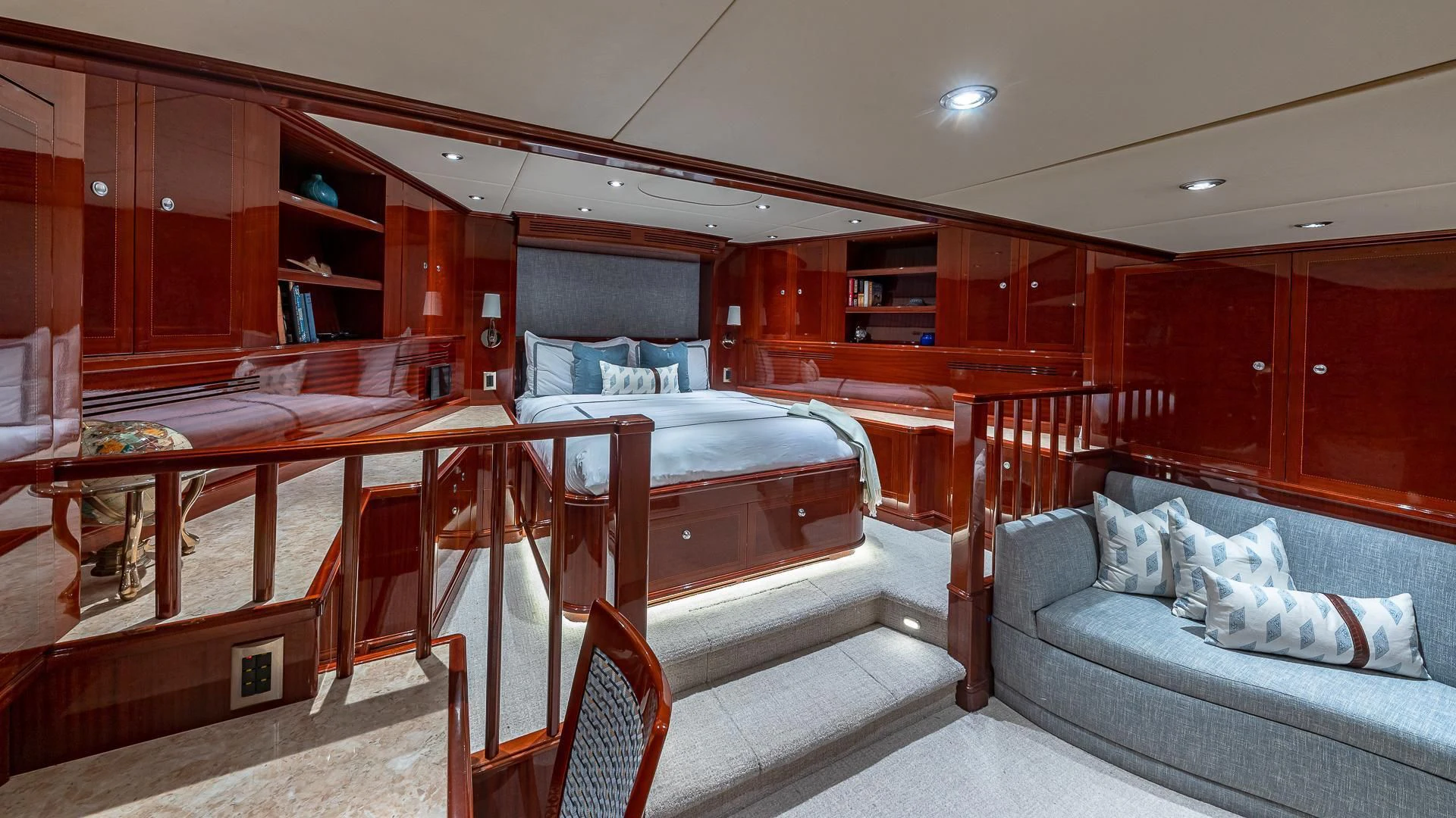 a bedroom with a bed and a couch aboard KASHMIR Yacht for Charter