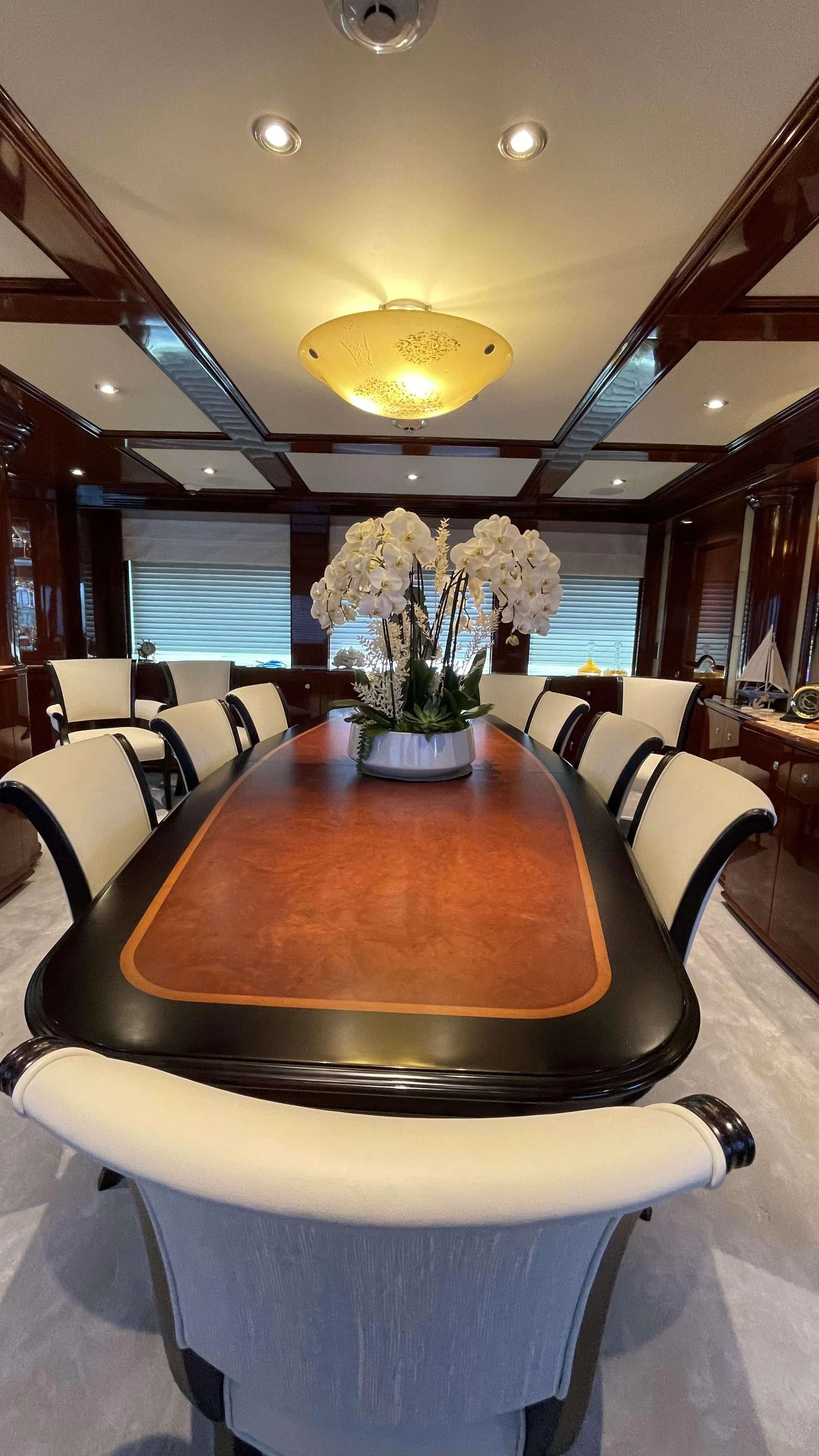 a table with white flowers on it aboard KASHMIR Yacht for Charter