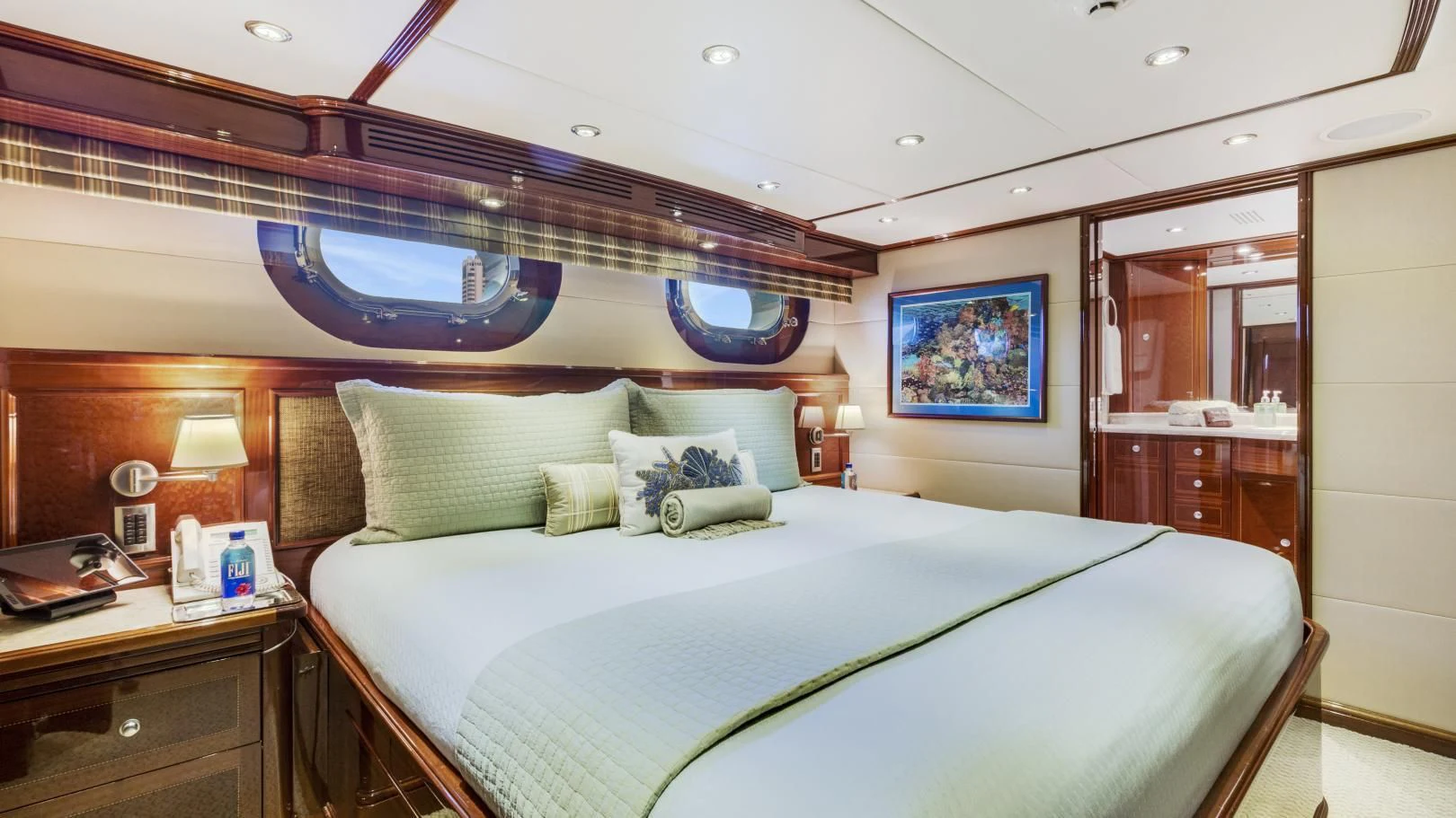 a bed with a blue bed spread aboard KASHMIR Yacht for Charter