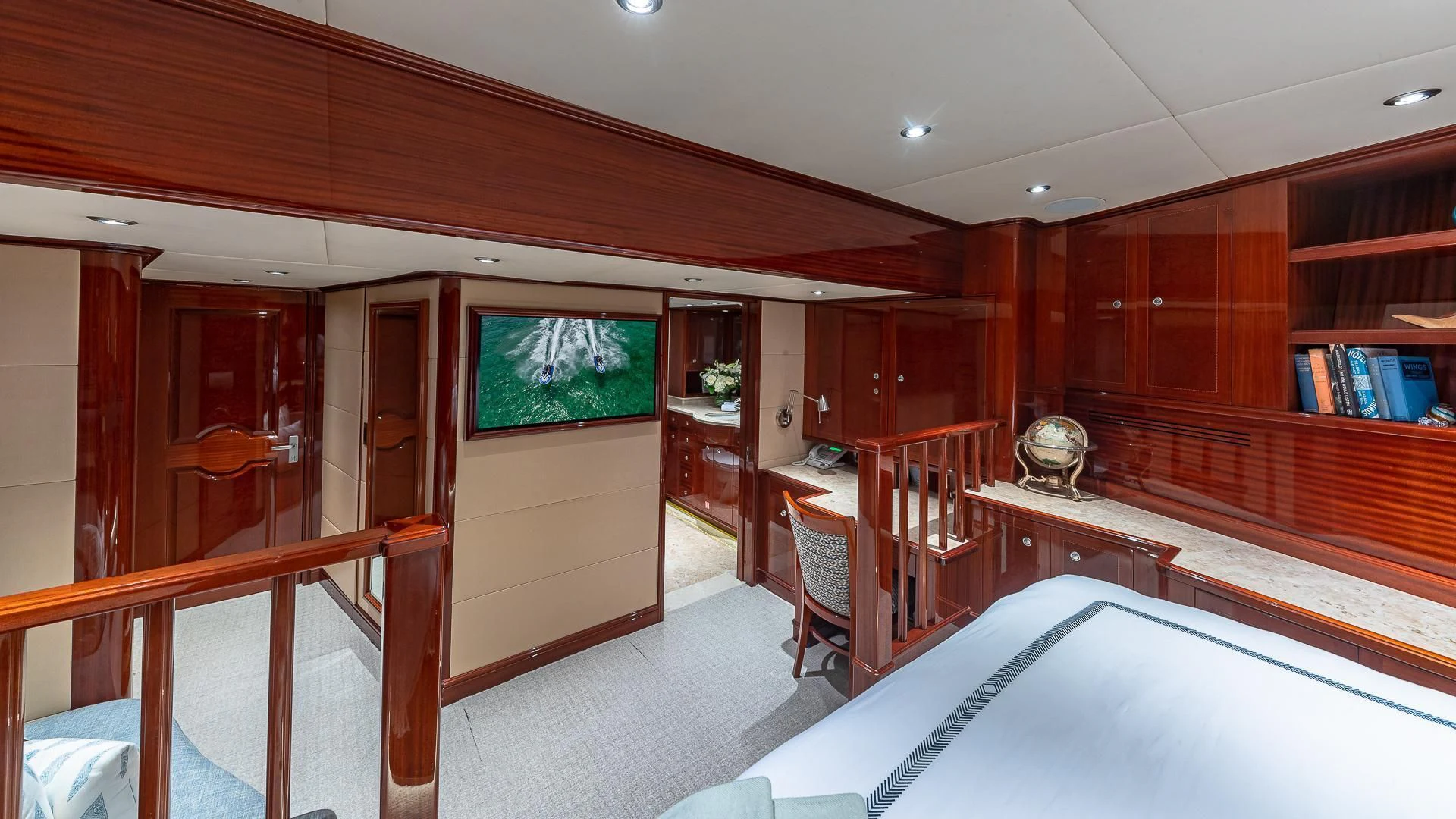 a room with a bed and a desk aboard KASHMIR Yacht for Charter
