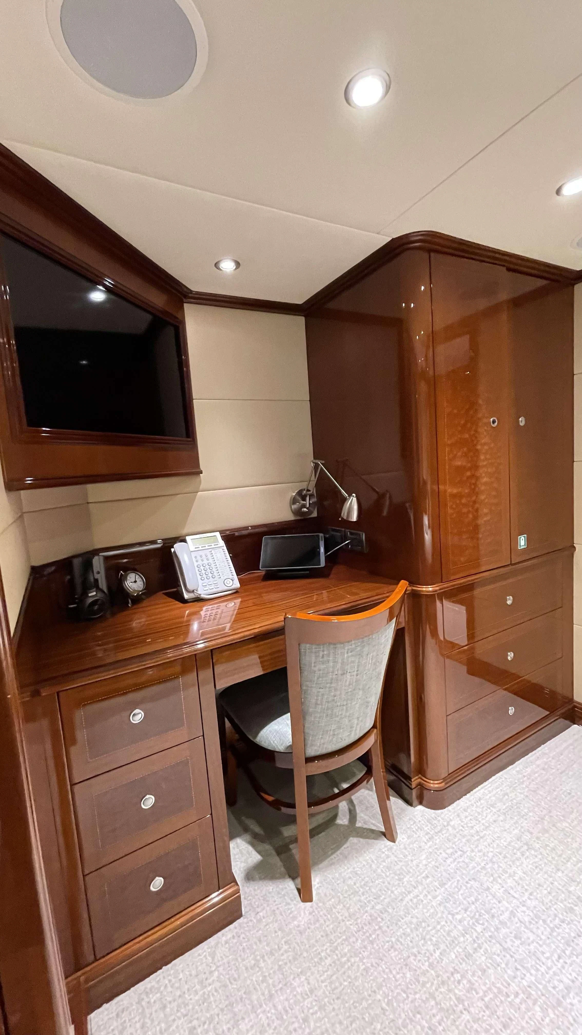 a desk with a chair and a computer on it aboard KASHMIR Yacht for Charter