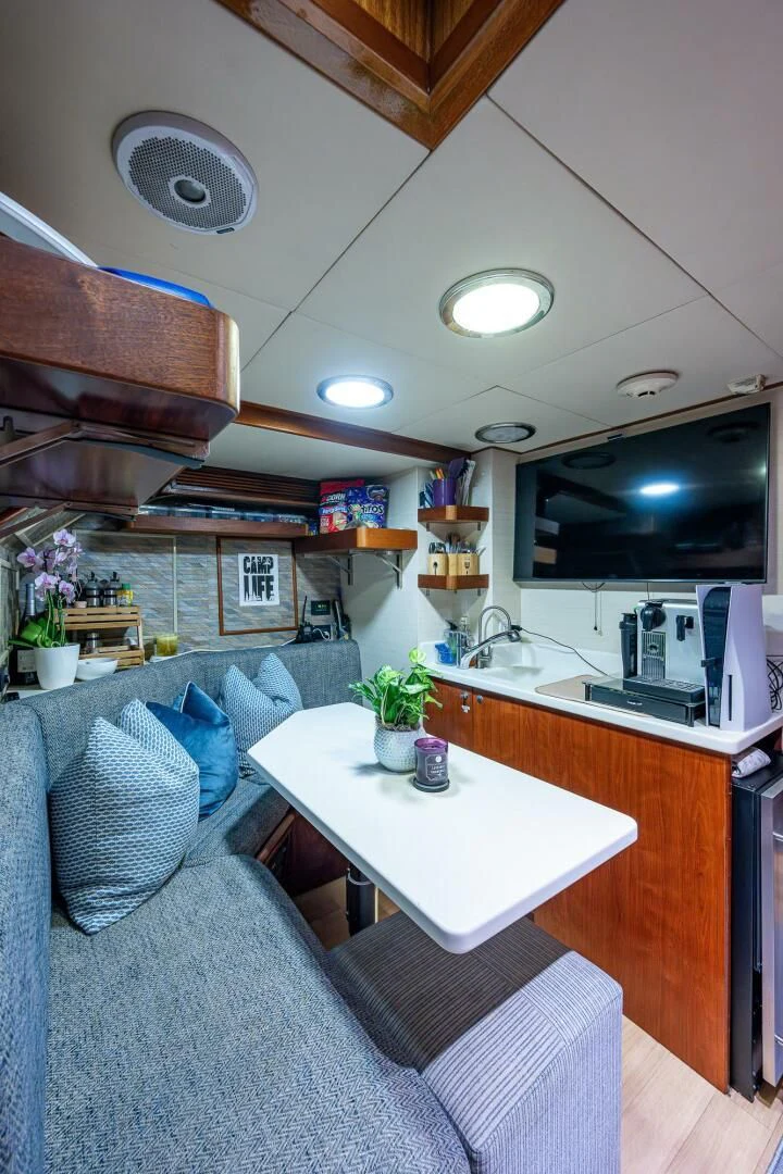 a living room with a couch and a table aboard KASHMIR Yacht for Charter