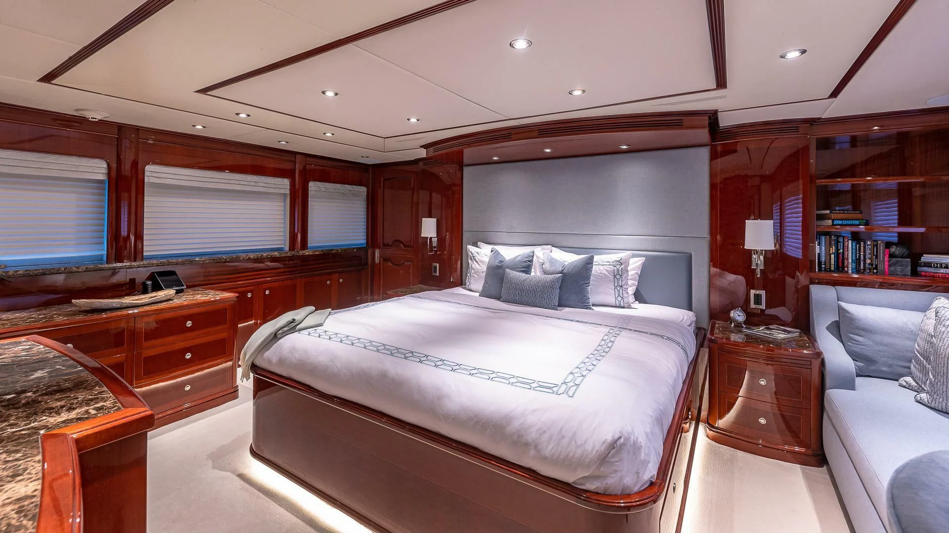 a bedroom with a bed and a desk aboard KASHMIR Yacht for Charter