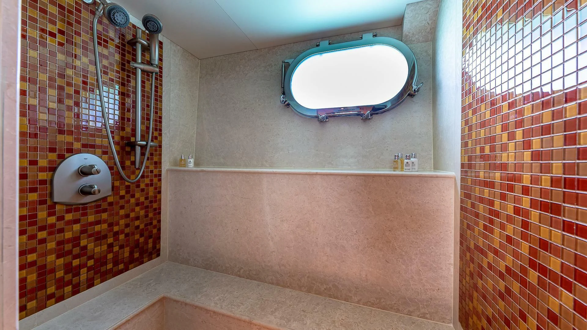 a bathroom with a round blue window aboard KASHMIR Yacht for Charter