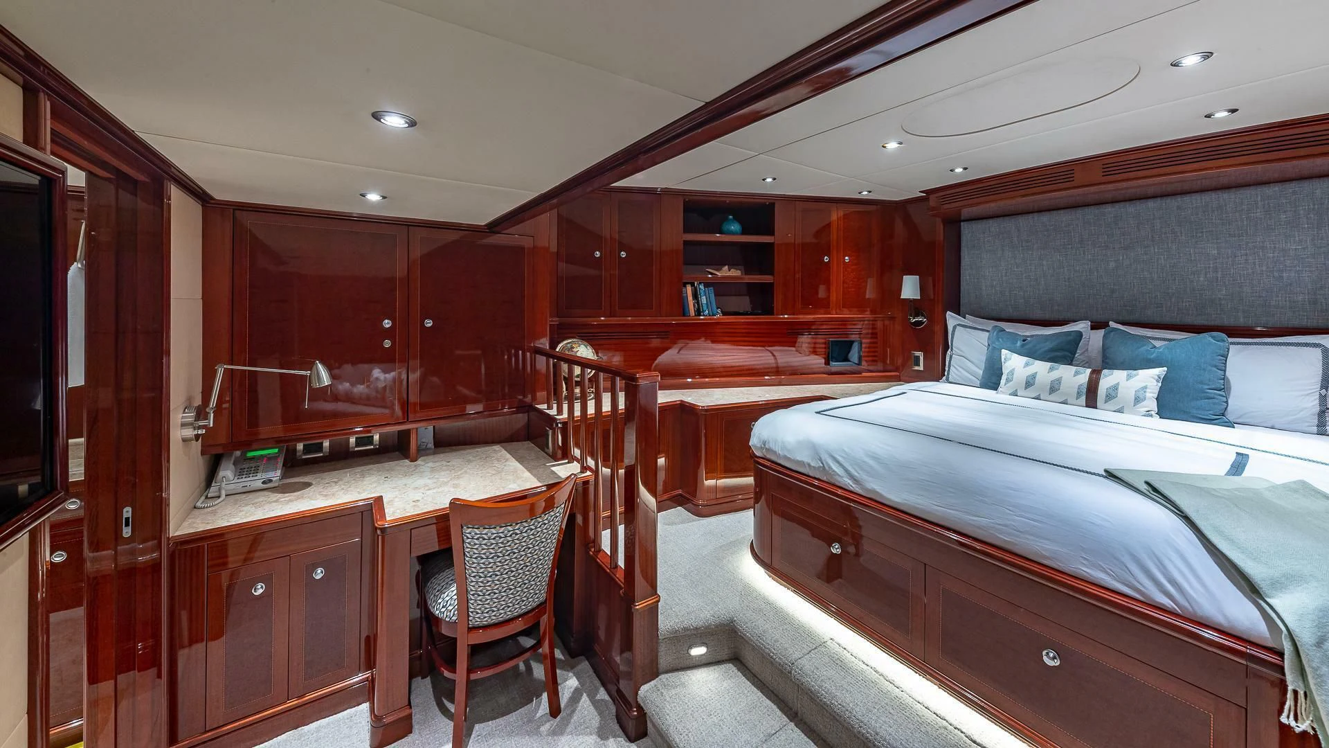 a room with a bed and desk aboard KASHMIR Yacht for Charter