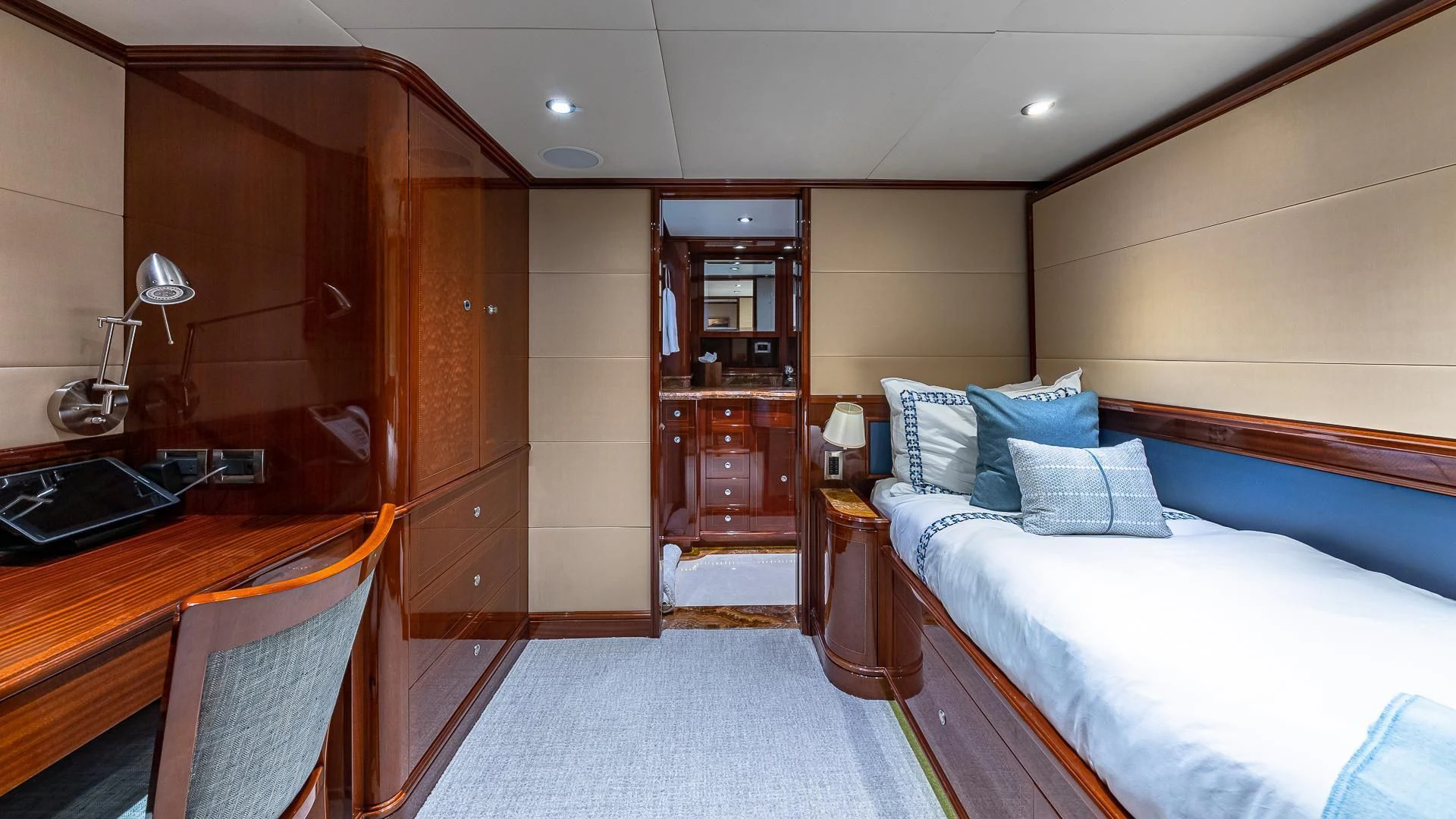 a room with a bed and a desk aboard KASHMIR Yacht for Charter