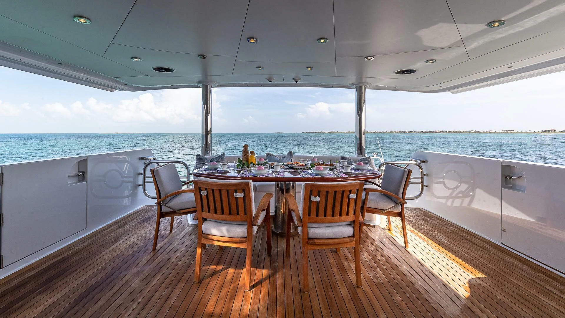 a table on a deck overlooking the ocean aboard KASHMIR Yacht for Charter