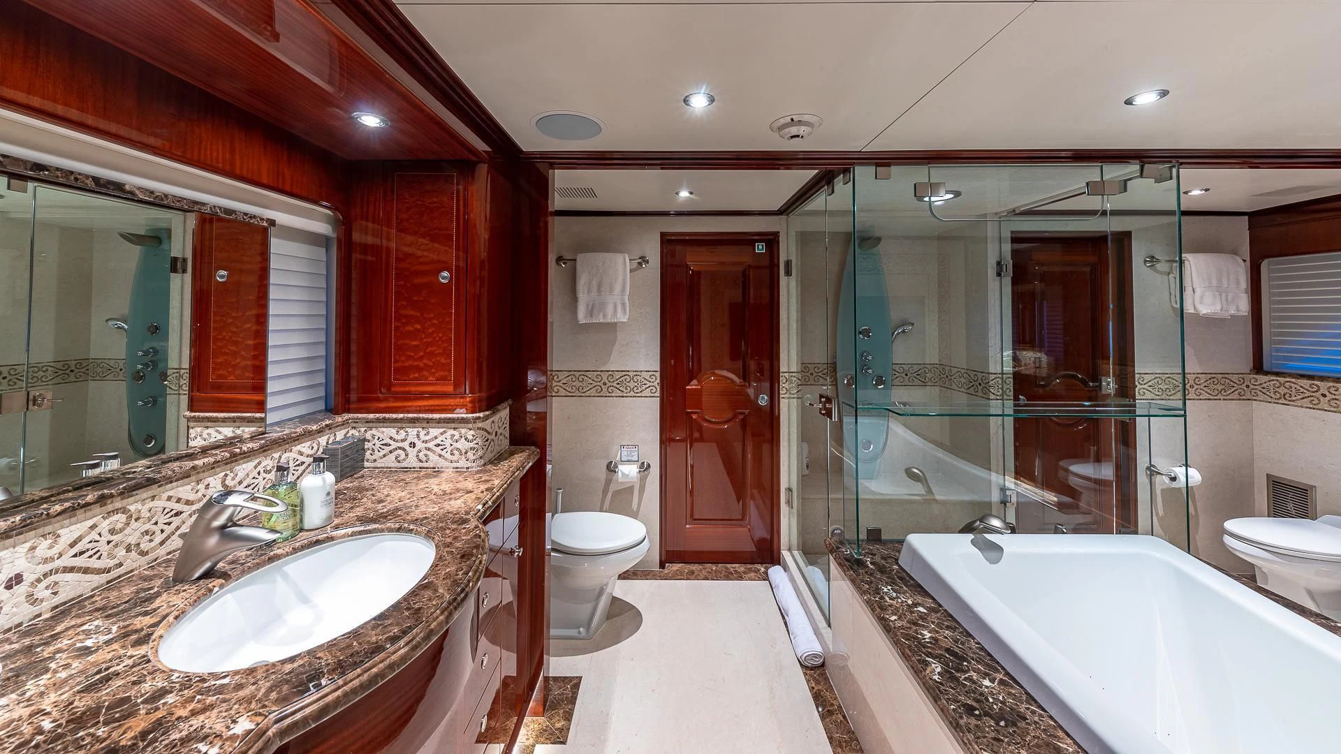 a bathroom with a large glass shower aboard KASHMIR Yacht for Charter