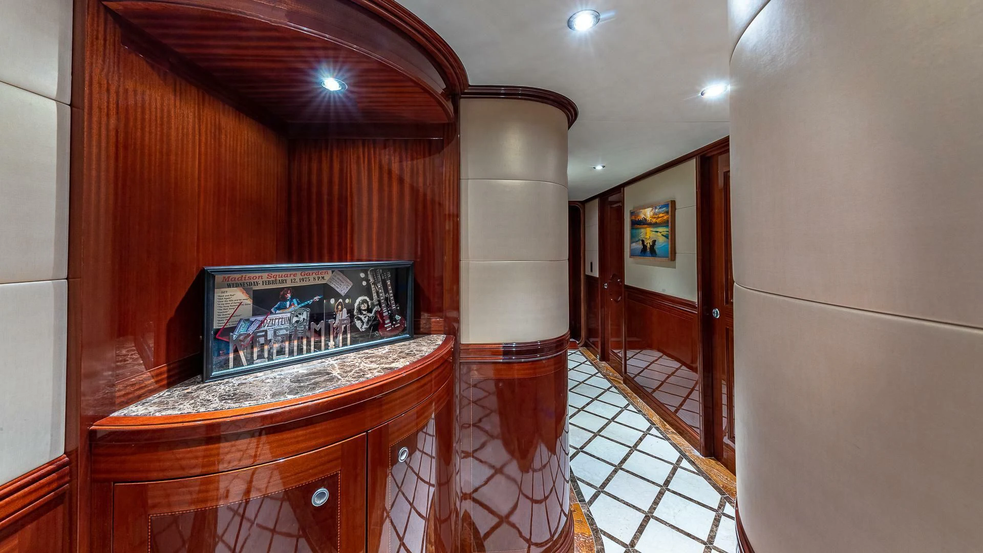 a room with a tv and a wood door aboard KASHMIR Yacht for Charter