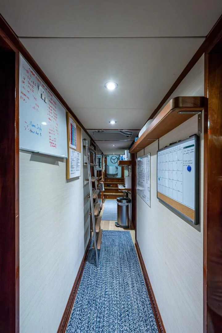 a hallway with signs on the wall aboard KASHMIR Yacht for Charter