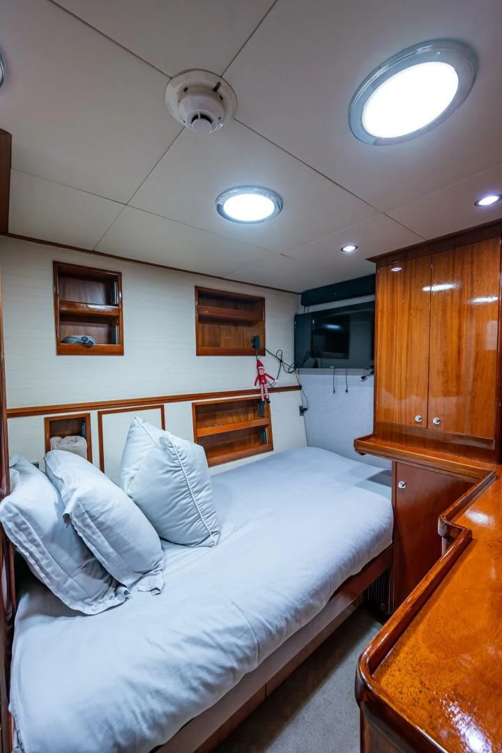 a bedroom with a bed and a television aboard KASHMIR Yacht for Charter