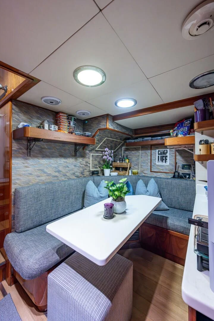 a living room with a couch and a table aboard KASHMIR Yacht for Charter