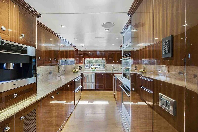a kitchen with wooden cabinets aboard KASHMIR Yacht for Charter
