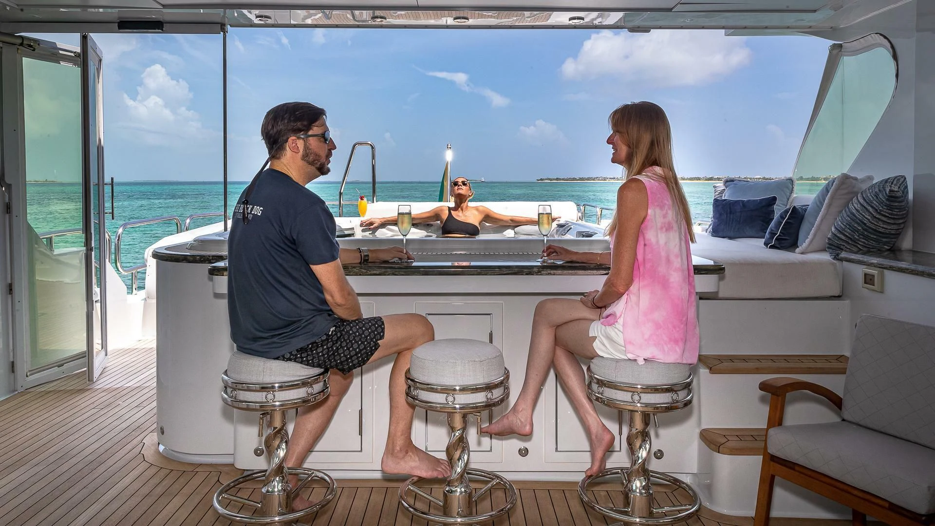 a man and woman sitting on a boat in the water aboard KASHMIR Yacht for Charter
