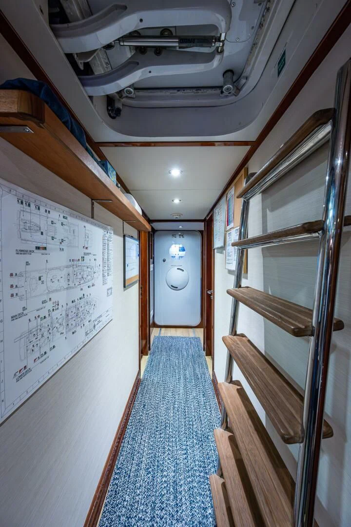 a hallway with wood railings aboard KASHMIR Yacht for Charter