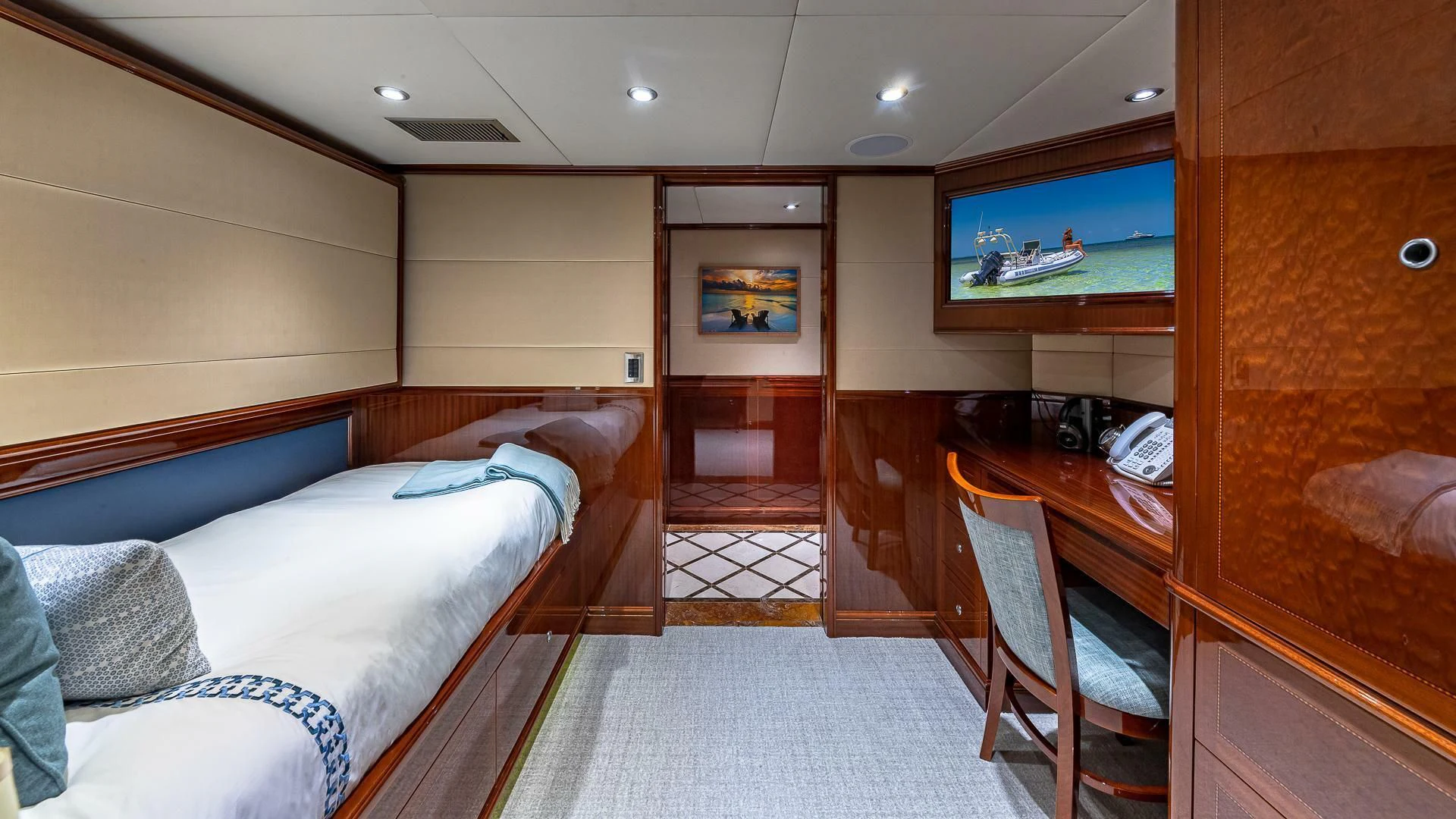 a room with a bed and a desk aboard KASHMIR Yacht for Charter