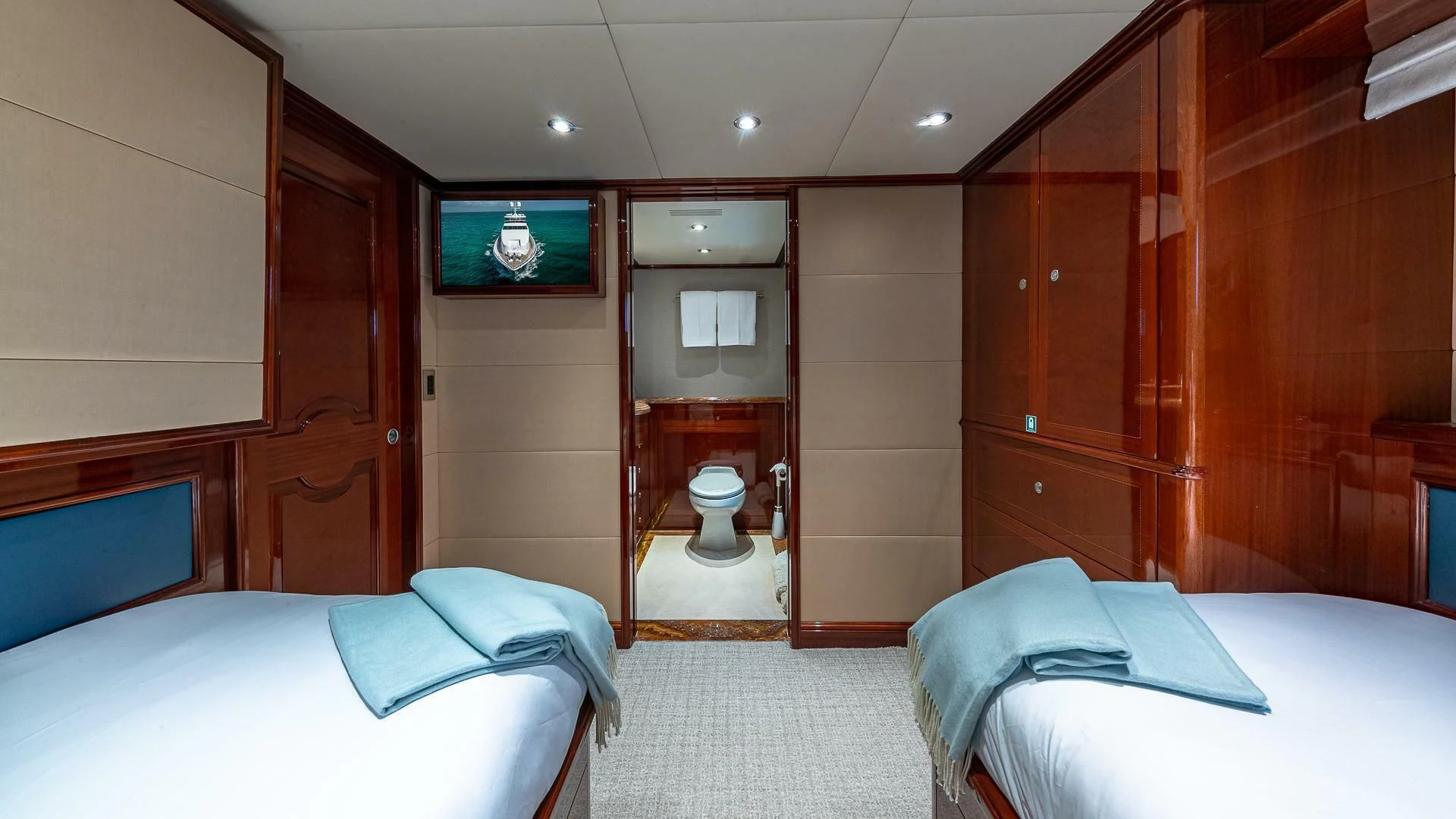 a room with a bed and a closet aboard KASHMIR Yacht for Charter