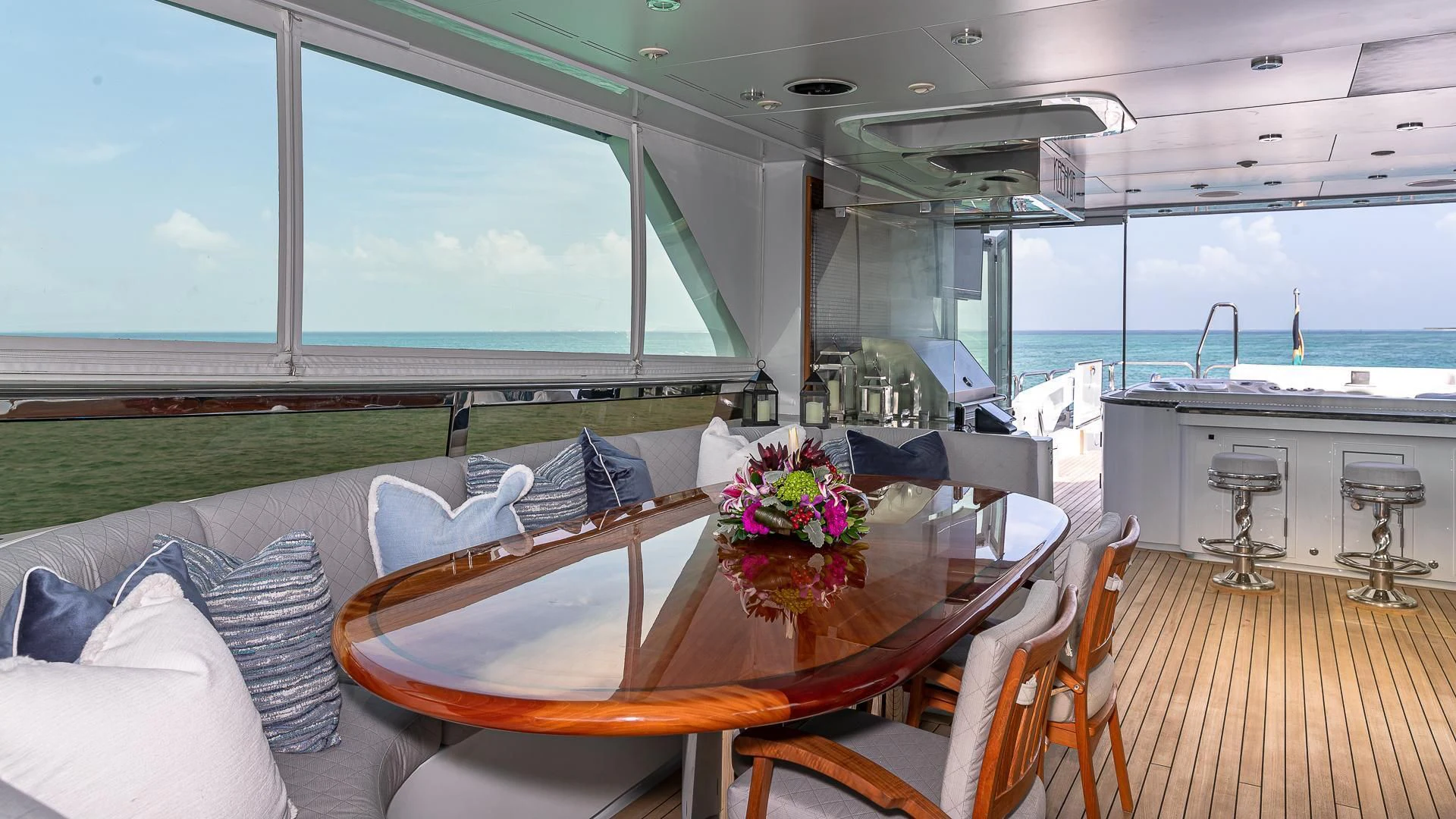 a table with chairs and a view of the ocean aboard KASHMIR Yacht for Charter