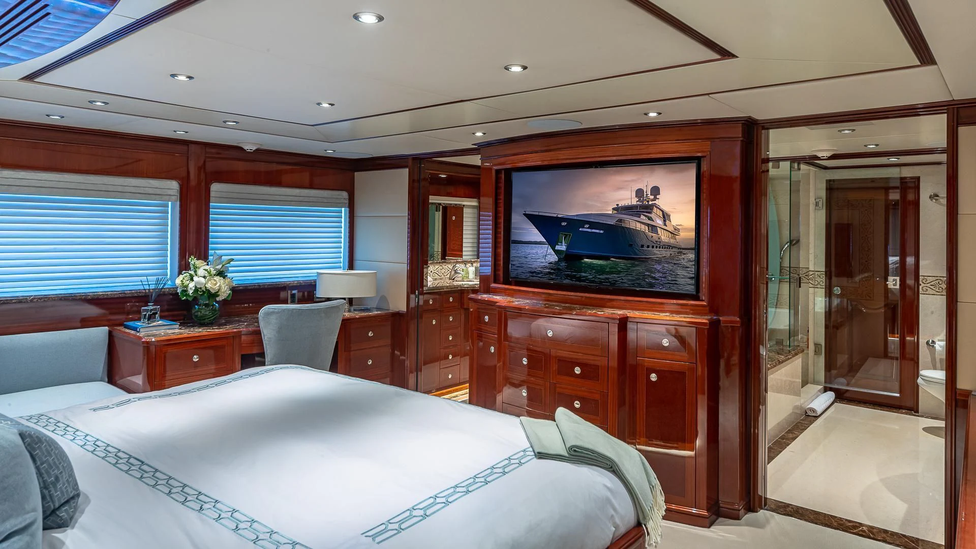 a bedroom with a bed and a tv on the wall aboard KASHMIR Yacht for Charter