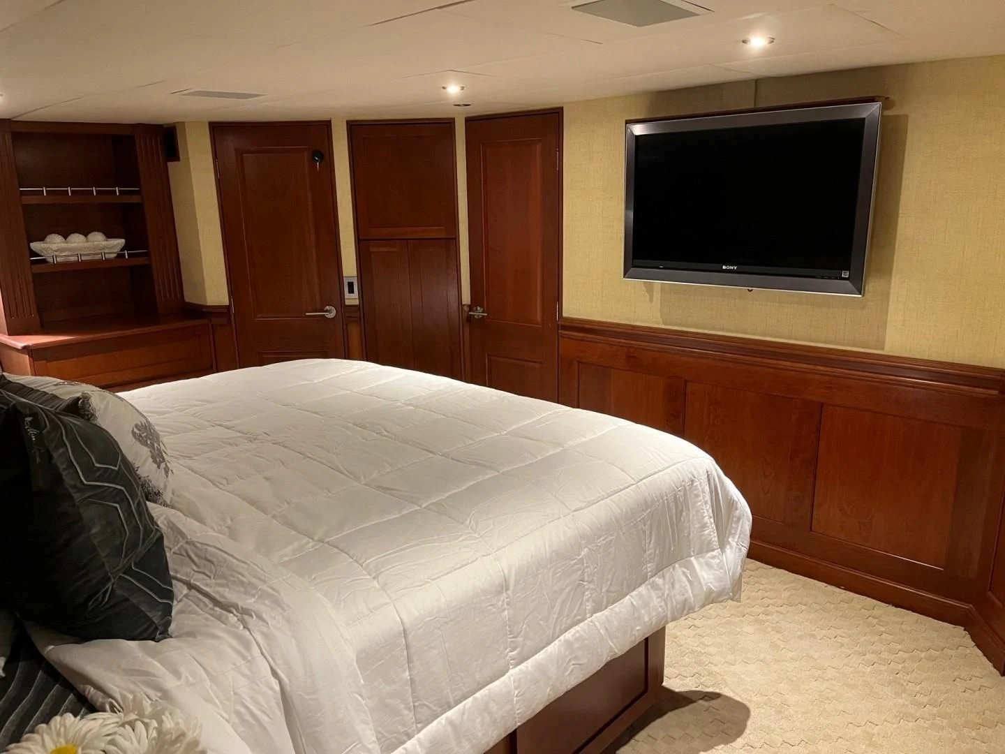 a bedroom with a bed and tv aboard SEAQUEST Yacht for Sale