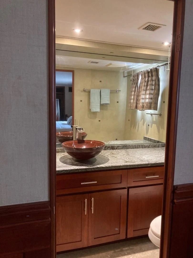 a bathroom with a large mirror aboard SEAQUEST Yacht for Sale