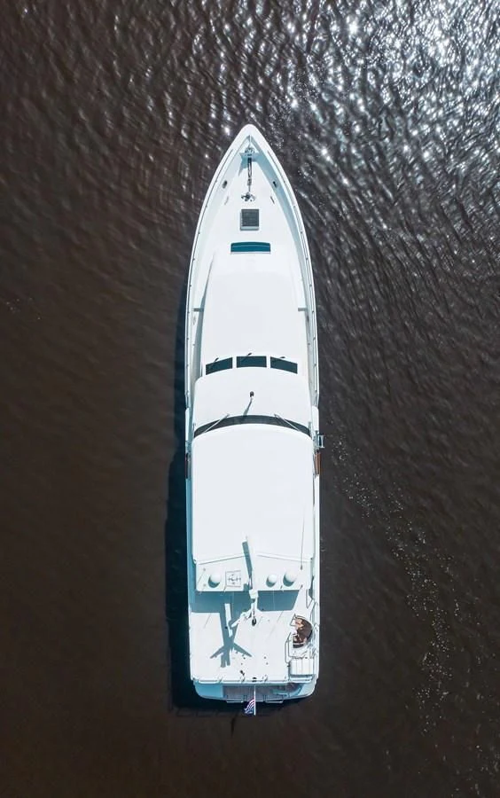 a white and blue boat on a wooden surface aboard SEAQUEST Yacht for Sale
