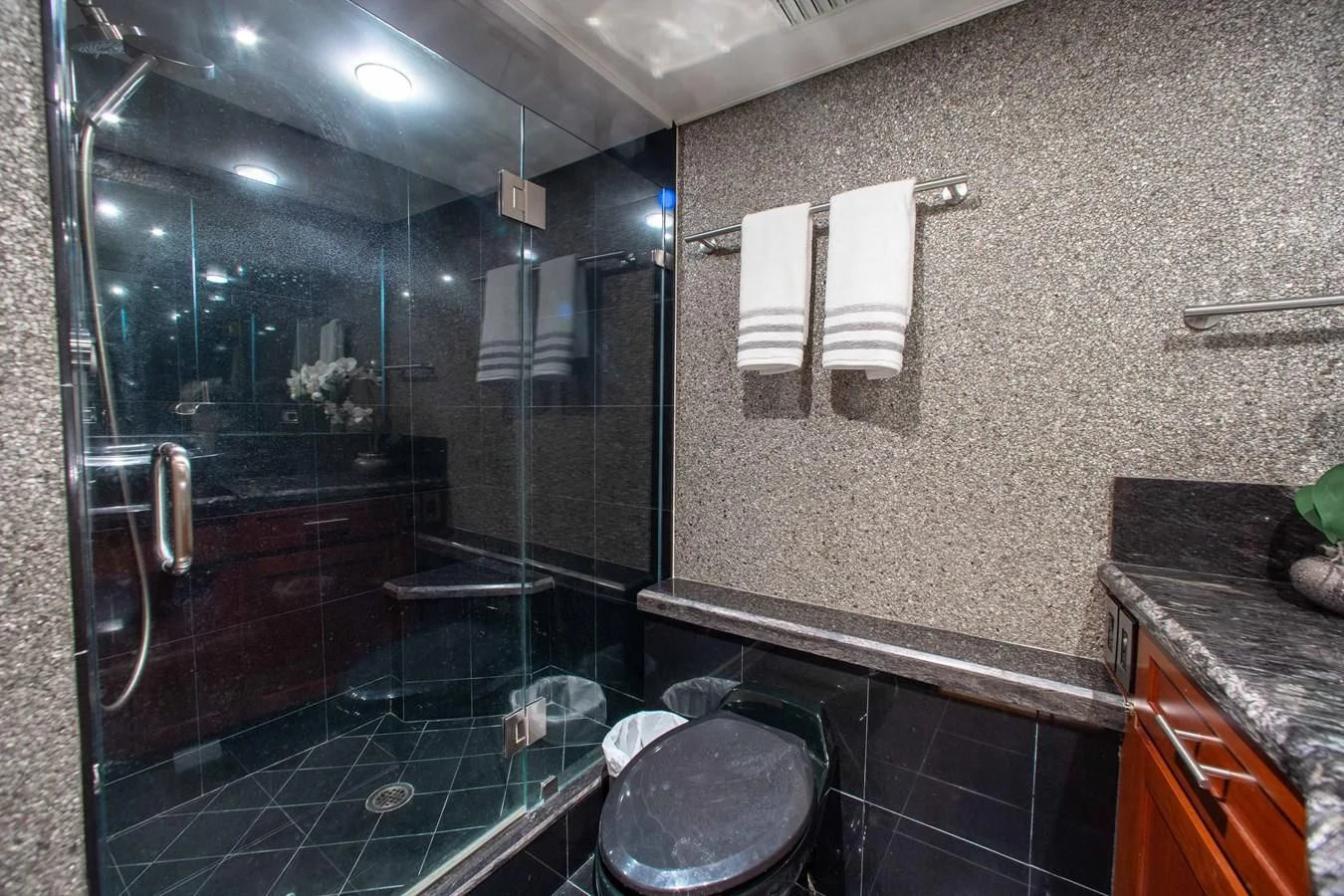 a bathroom with a glass shower aboard SEAQUEST Yacht for Sale