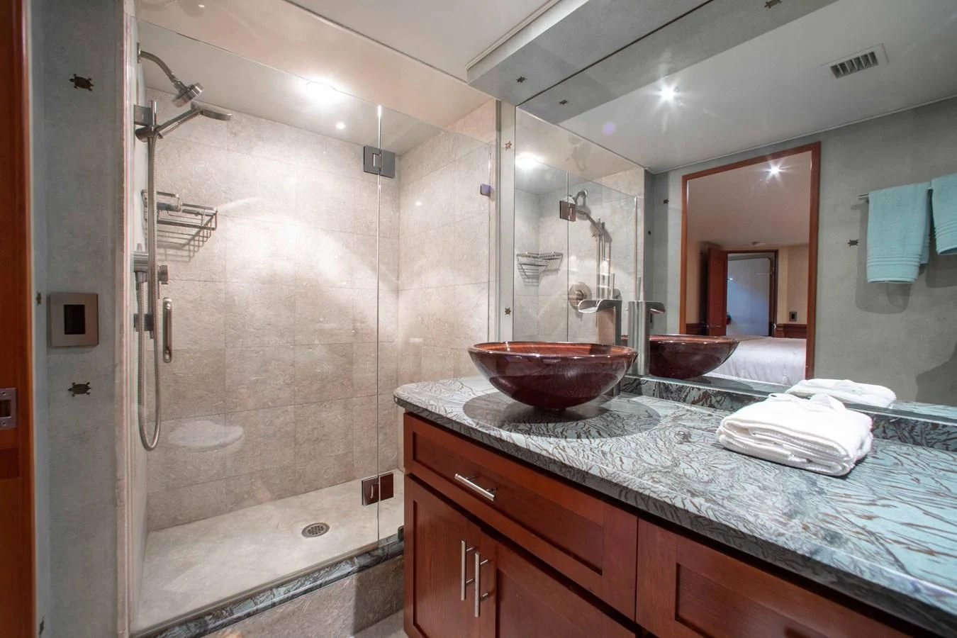 a bathroom with a glass shower aboard SEAQUEST Yacht for Sale